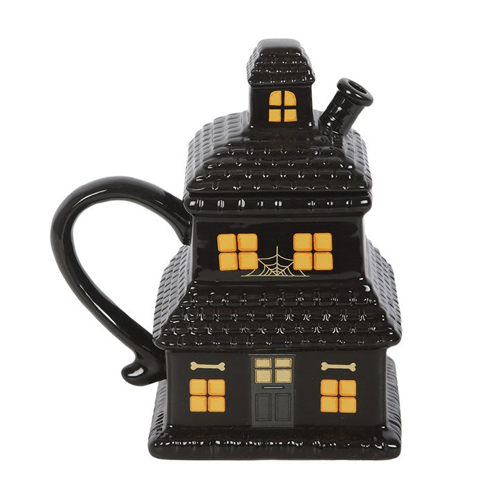 Schwarze Tasse mit Spukhaus-Motiv