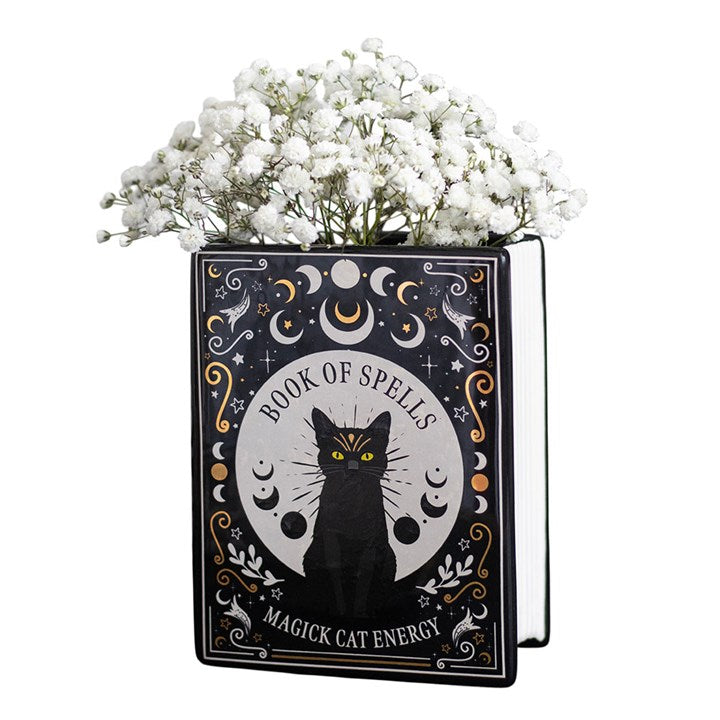Blumenvase in Form eines Buches mit schwarzer Katze