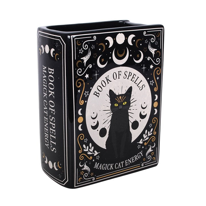 Blumenvase in Form eines Buches mit schwarzer Katze