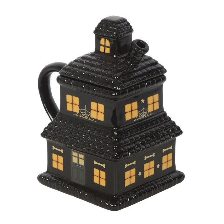 Schwarze Tasse mit Spukhaus-Motiv